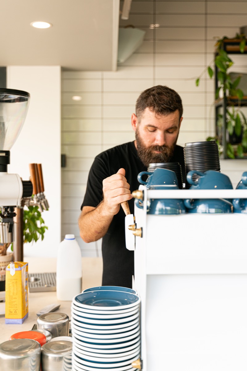 A Toscas barista pulling an espresso shot