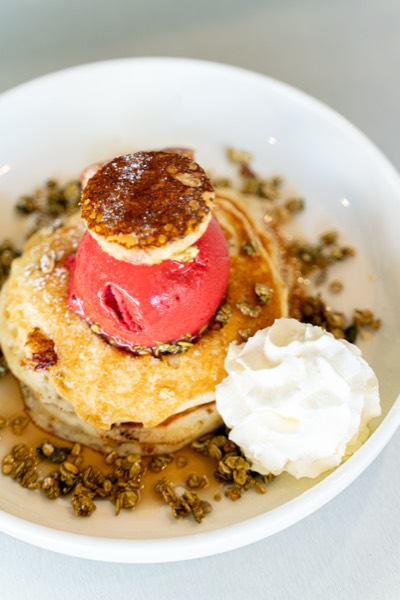Pancakes with berry sorbet, cream and crumble